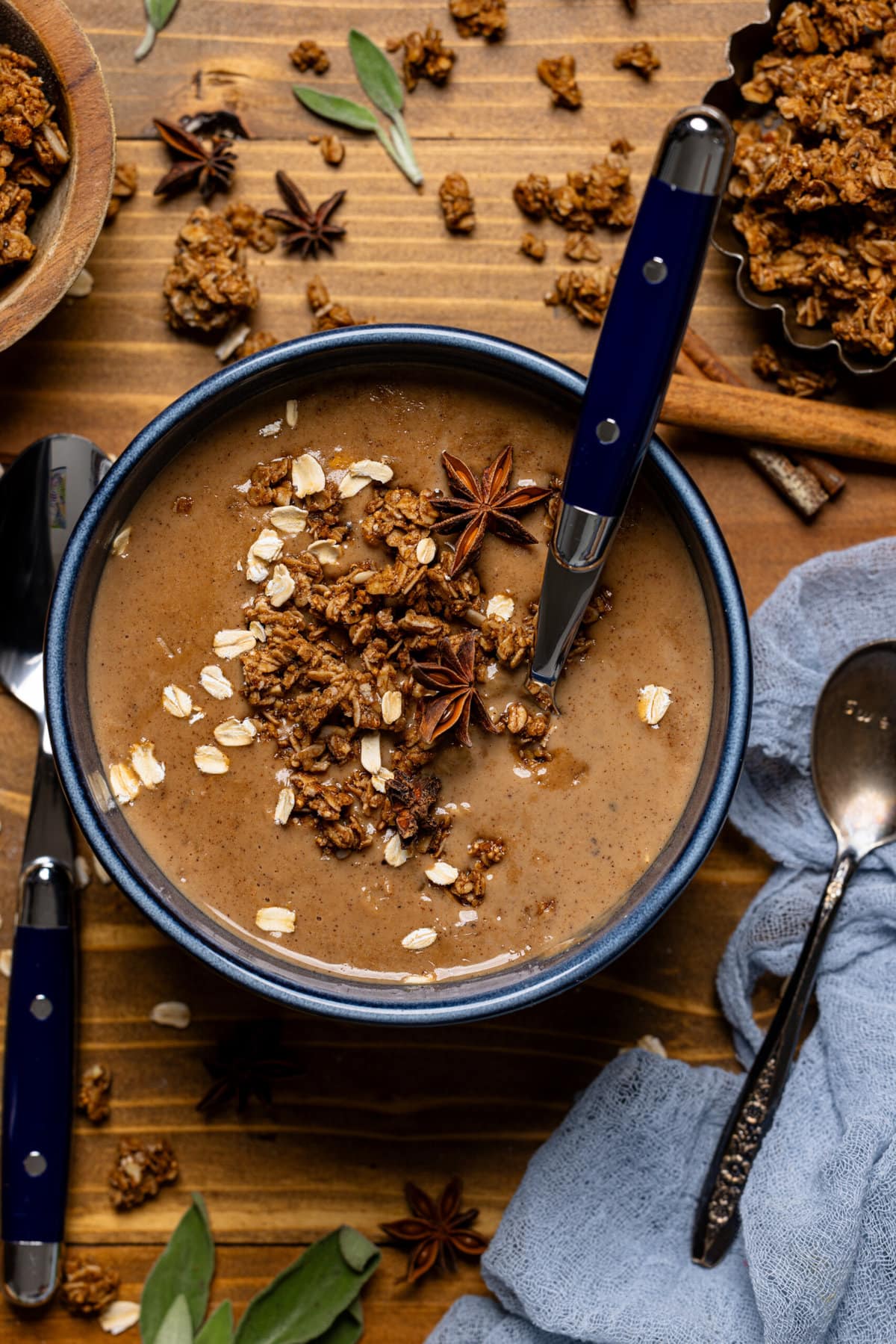 Up close shot of oatmeal in a bowl with a spoon and garnish.