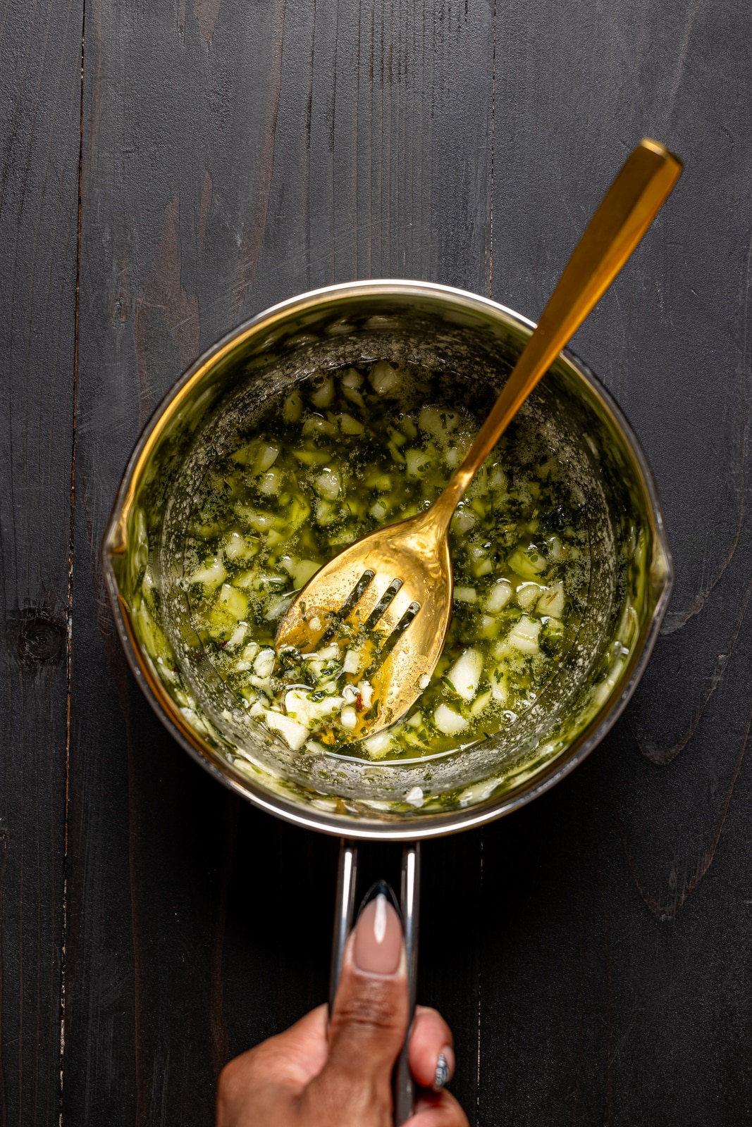 Garlic parmesan sauce in a silver saucepan.