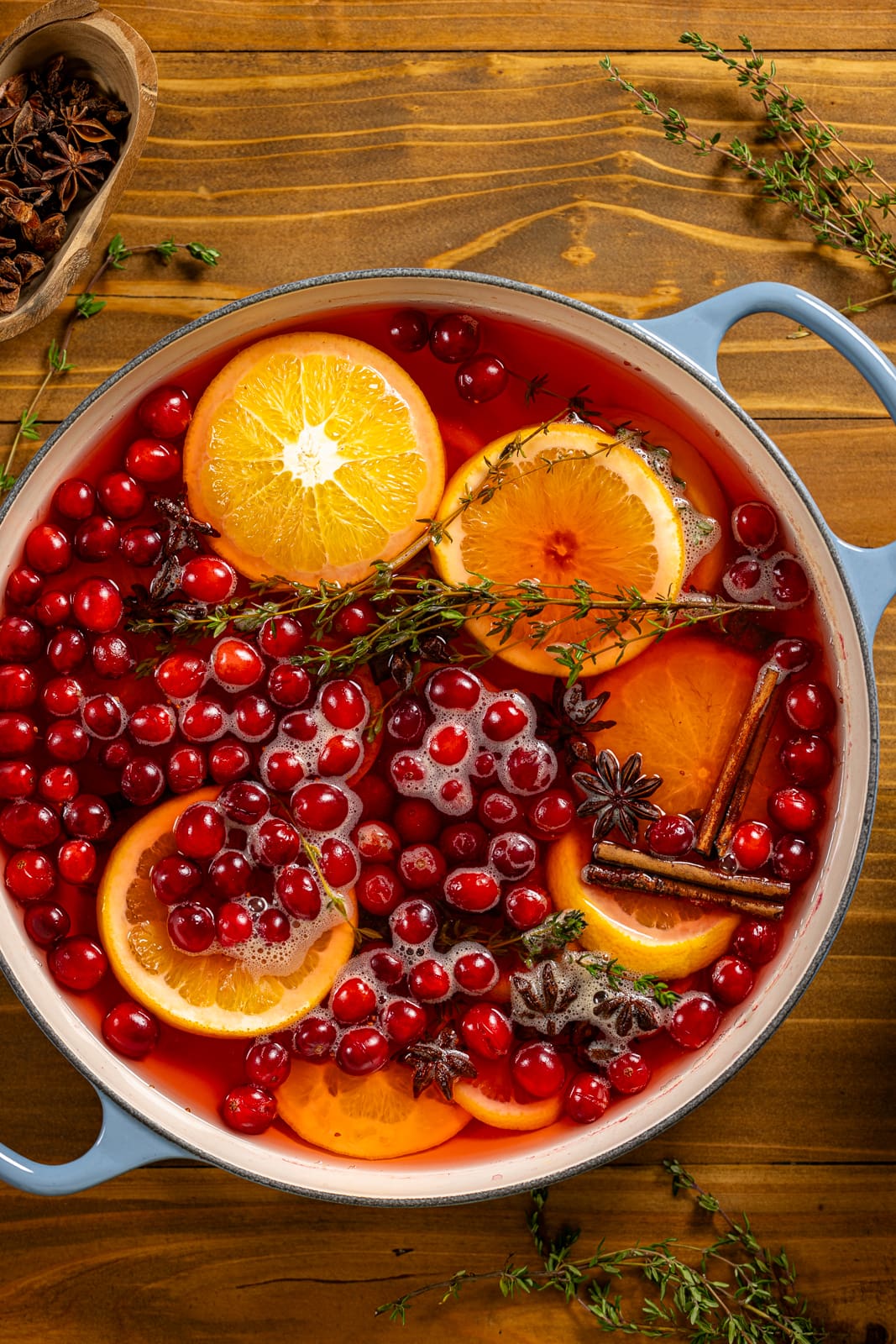 All ingredients in a blue pot for the holiday simmer pot.