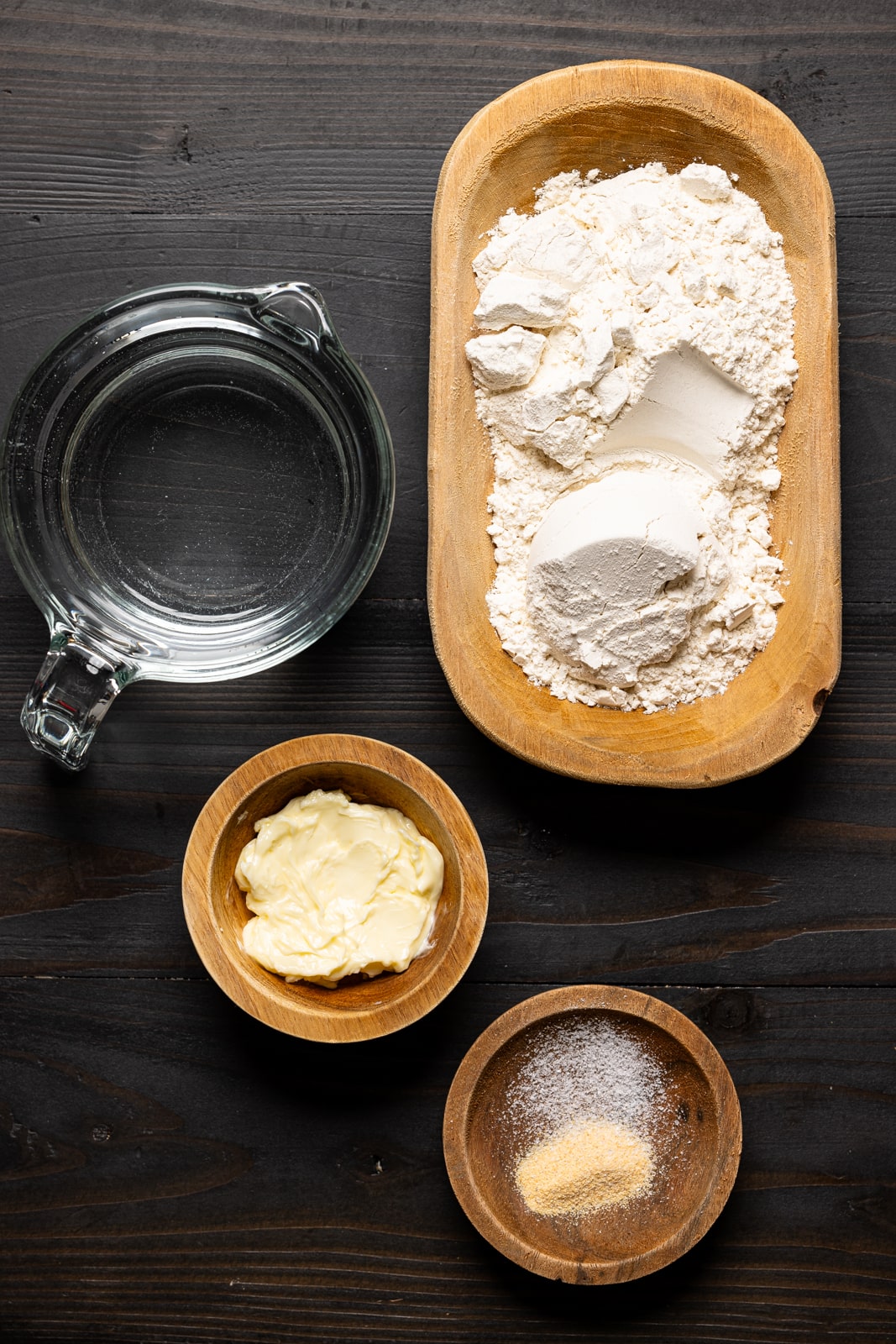 Ingredients on a black wood table.