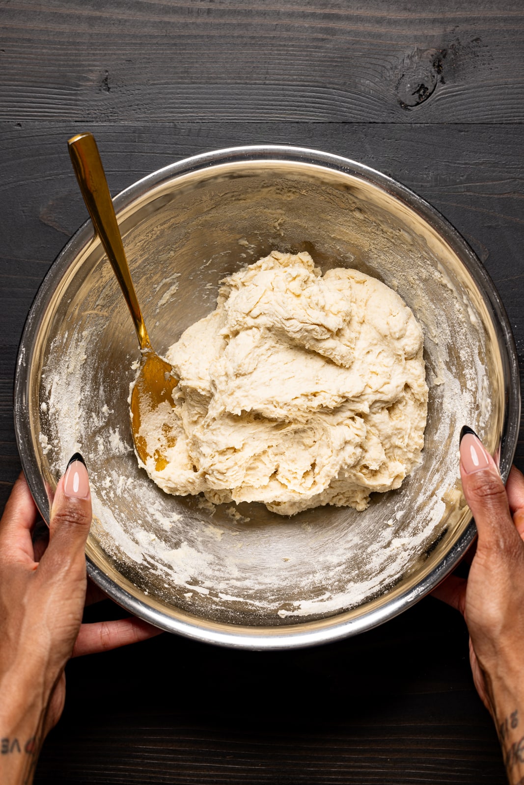 A silver bowl with the batter and a gold spoon.