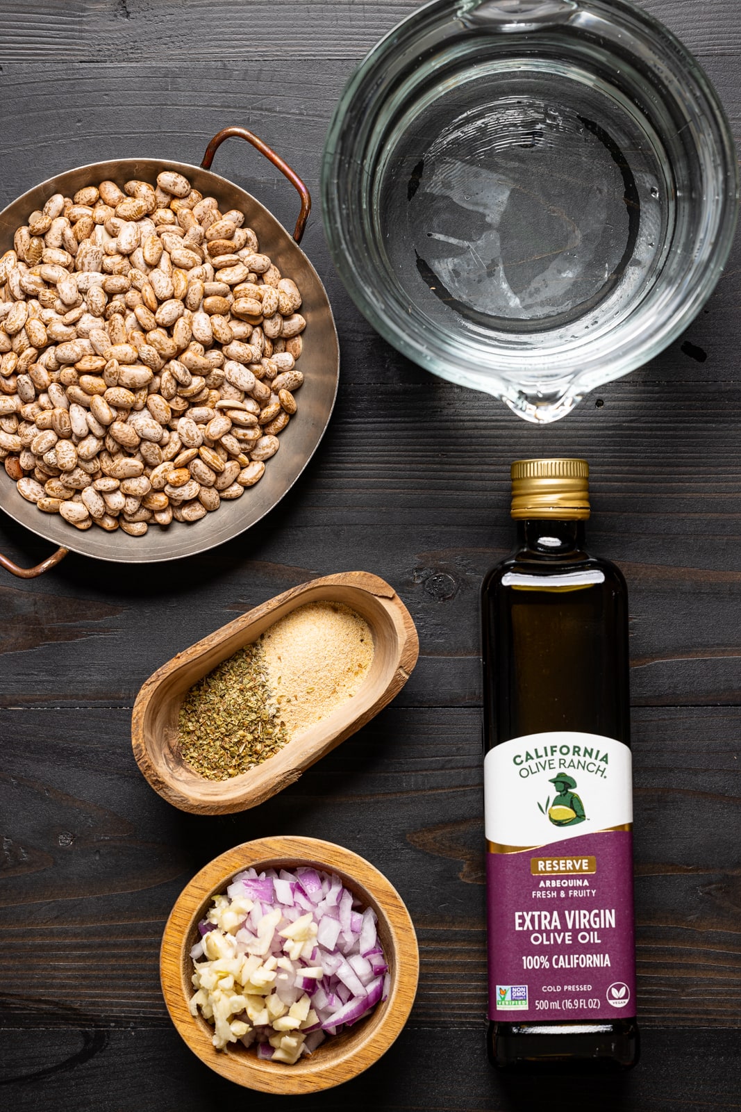 Ingredients on a black wood table.