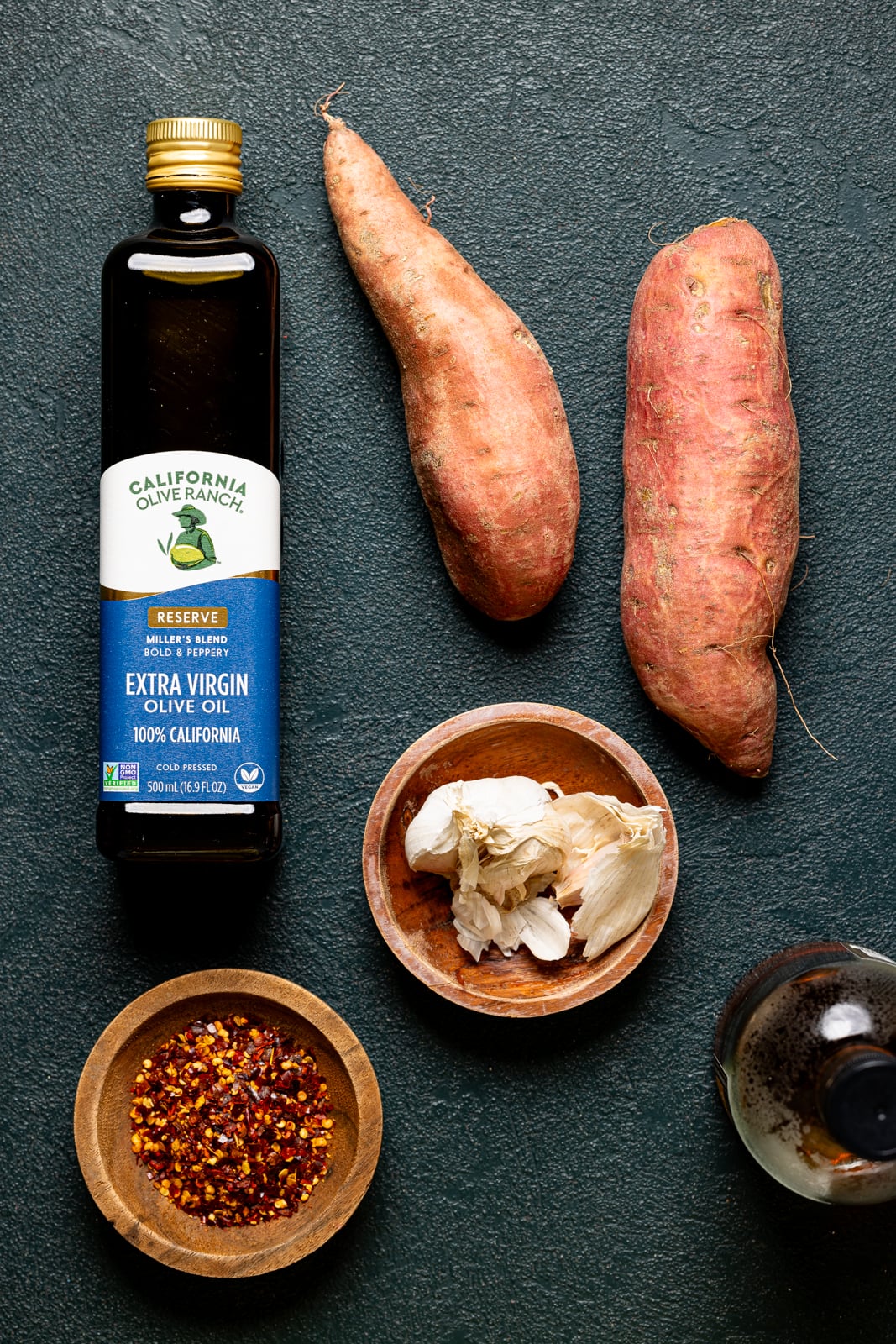 Ingredients on a dark green table.