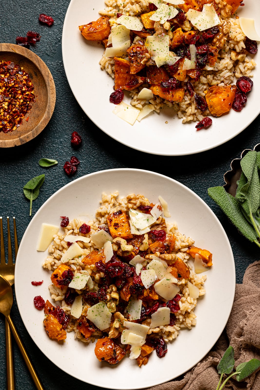 Sweet potato bowl in a two low bowls with cranberry and garnish.