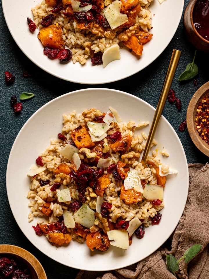 Sweet potato and ingredients shared in two low bowls with a fork.