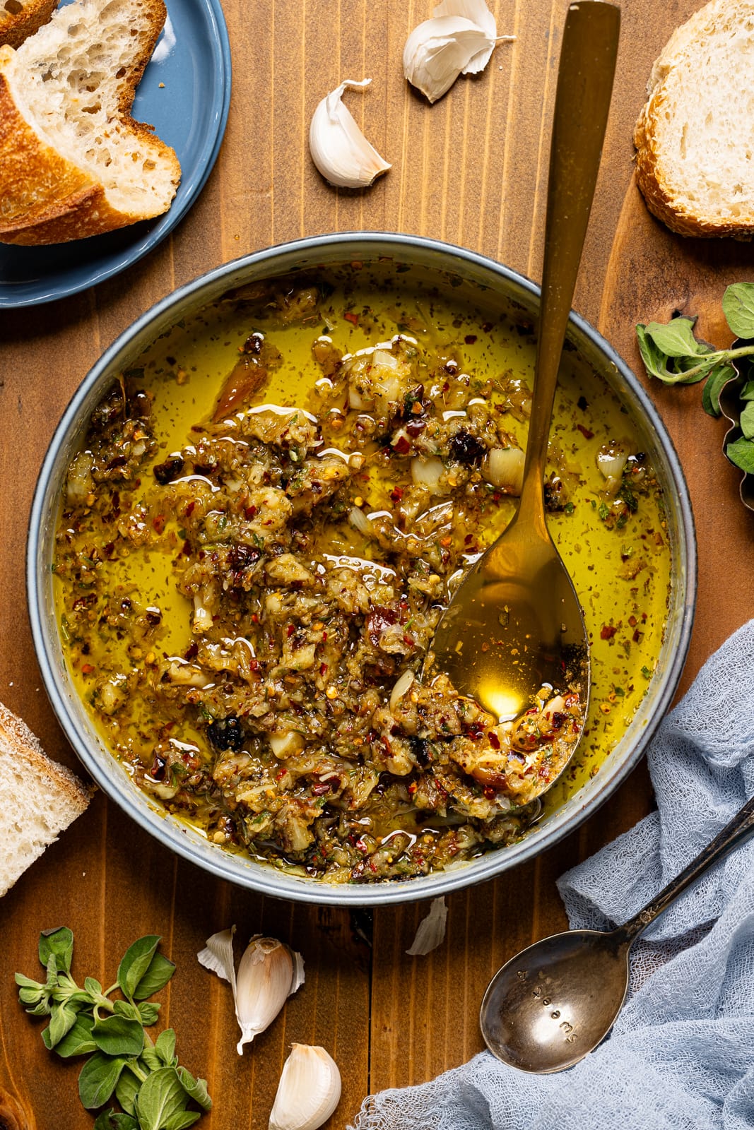 Dip in a bowl with a spoon, side of bread, and garnish.