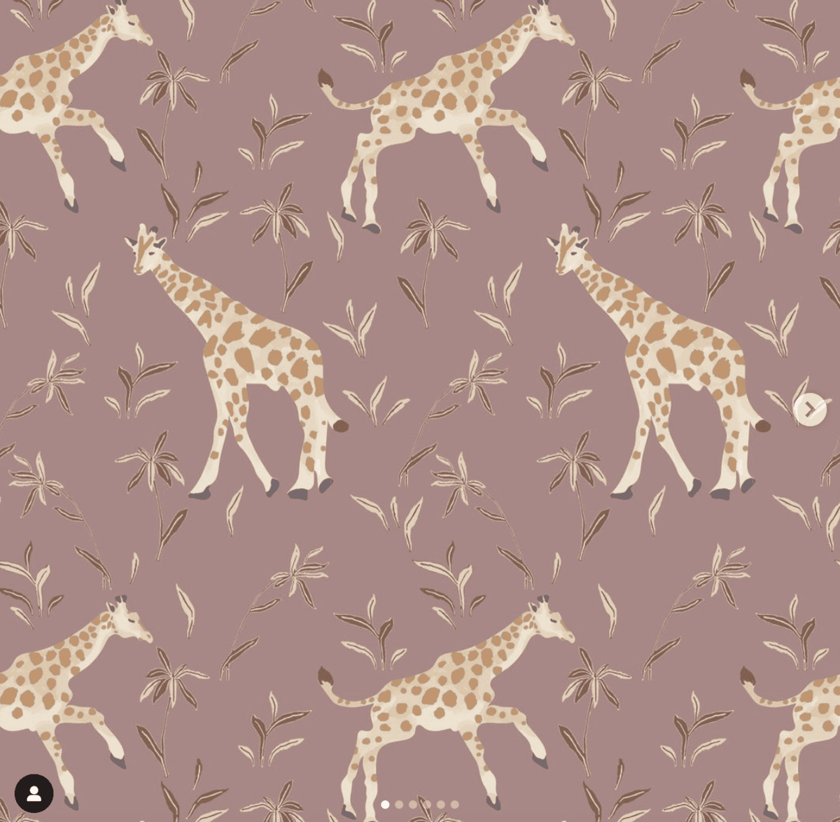 Image of wallpaper with pinkish background and giraffes. 