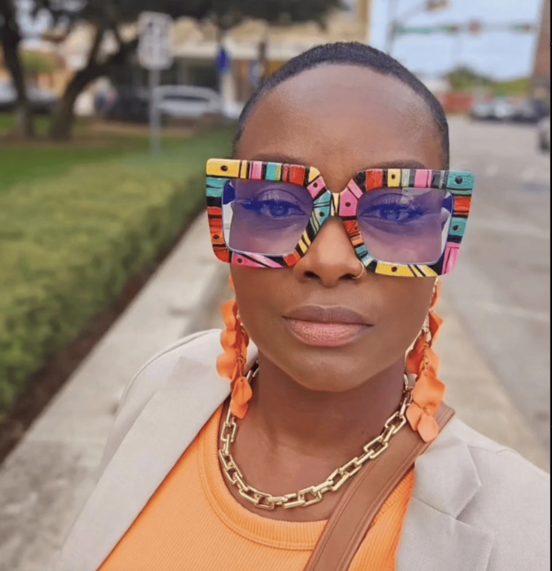 Image of woman in colorful patterned glasses. 