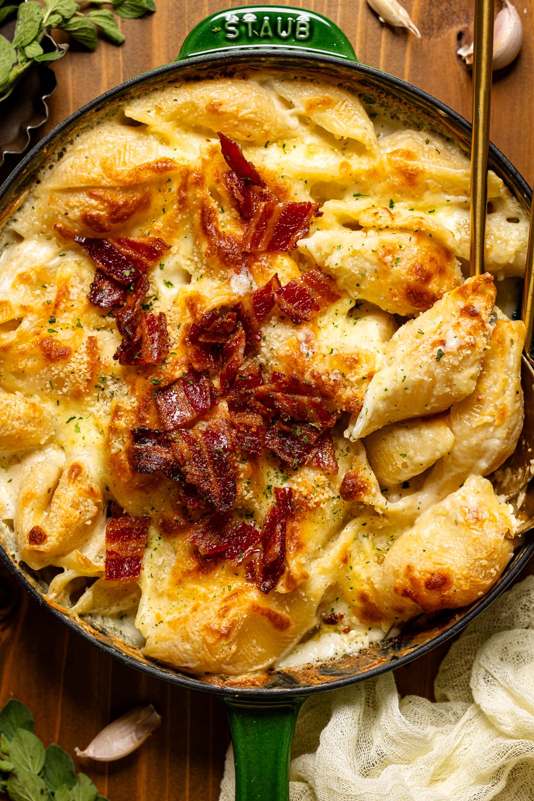 Up close shot of baked mac and cheese in a skillet with a spoon.