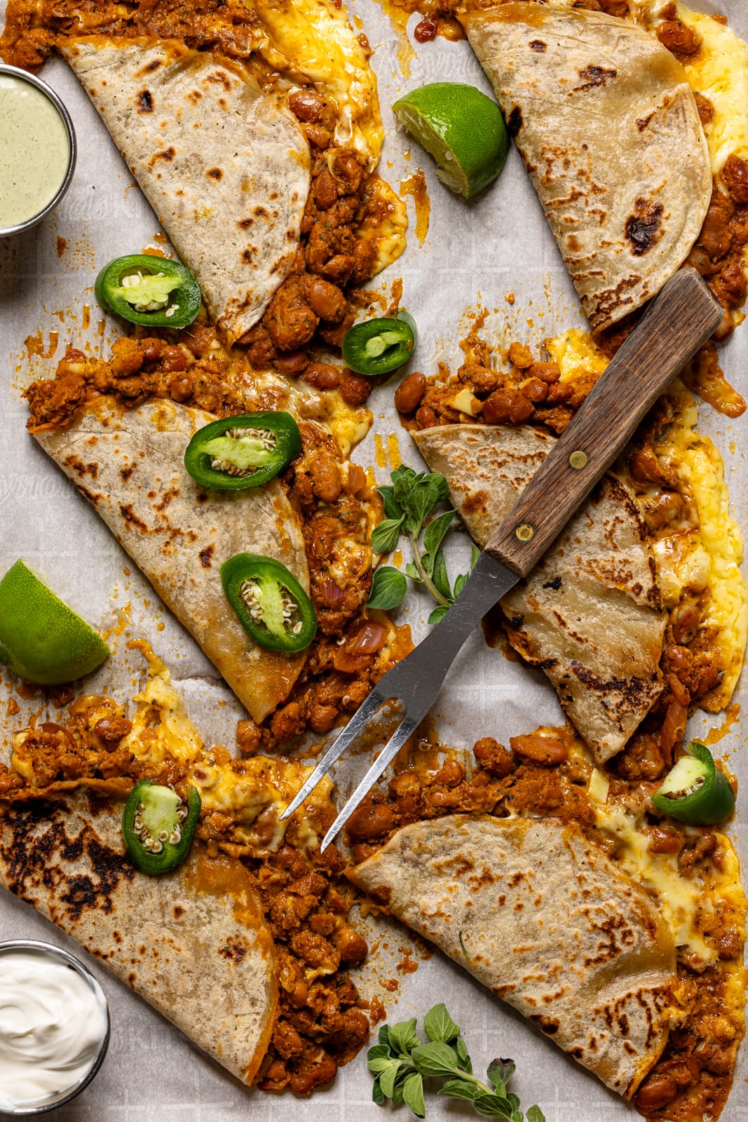 Baked  BBQ pinto bean tacos fresh out of the oven with a fork.