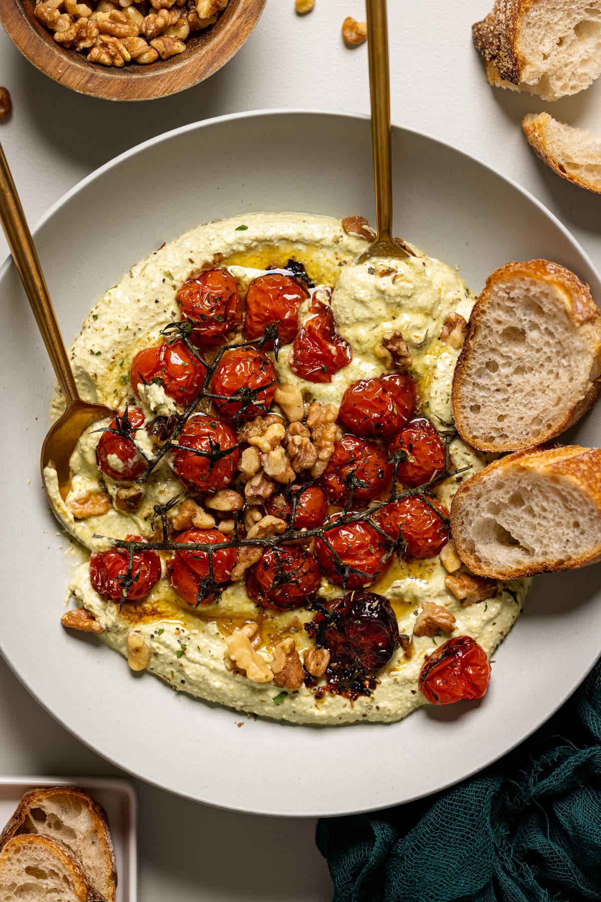 Up close shot of whipped feta dip with a spoon and fork with bread.