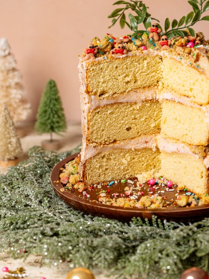 Layered cake with holiday wreath and ornaments.