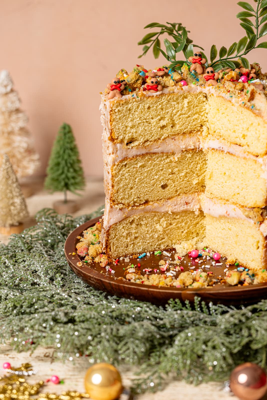 Layered cake with holiday wreath and ornaments.