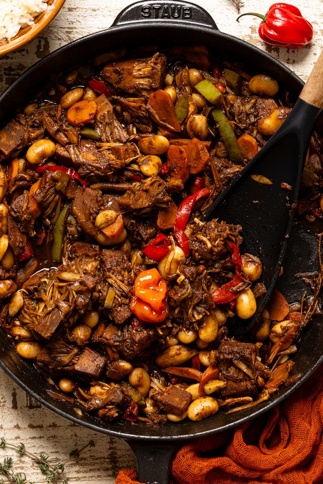 Up close shot of plant-based oxtail in a skillet with spoon.