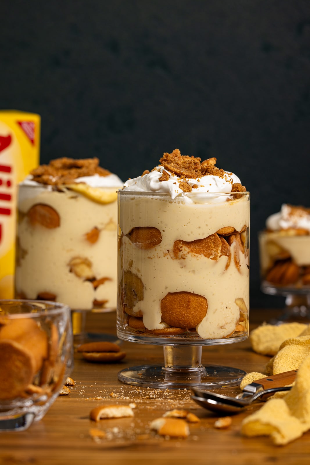Banana pudding in trifle bowls with vanilla wafer cookies.