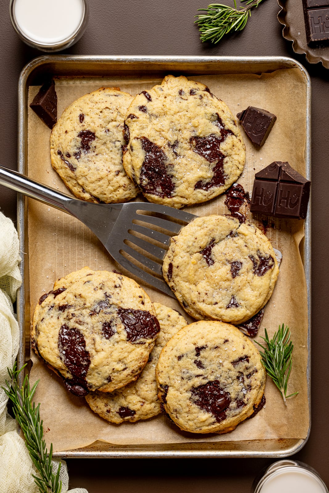 Cookies on a baking sheet with spatula. 