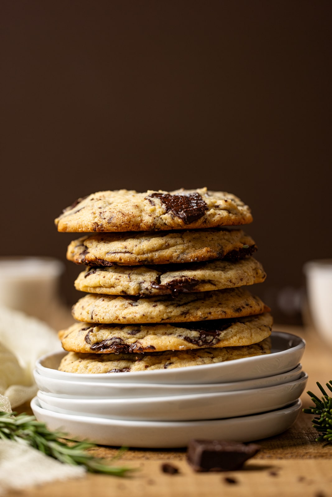 Stacks of cookies on stacks of plates.