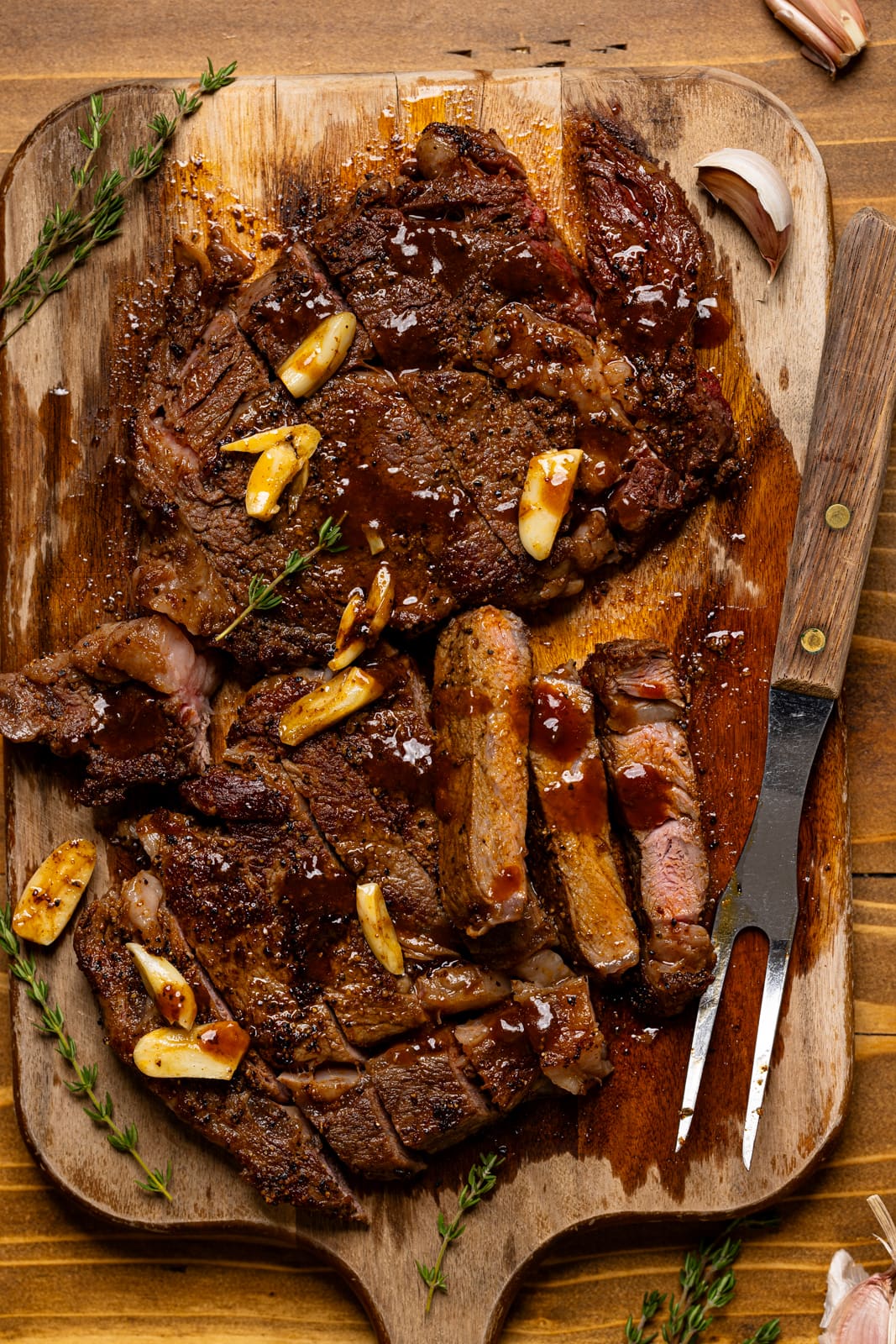 Up close shot of sliced steak with a fork and sauce.