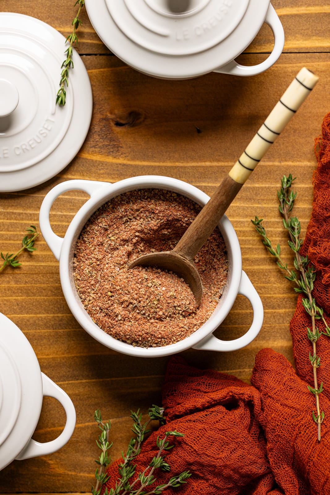 Mini white croquettes with seasoning and a spoon.