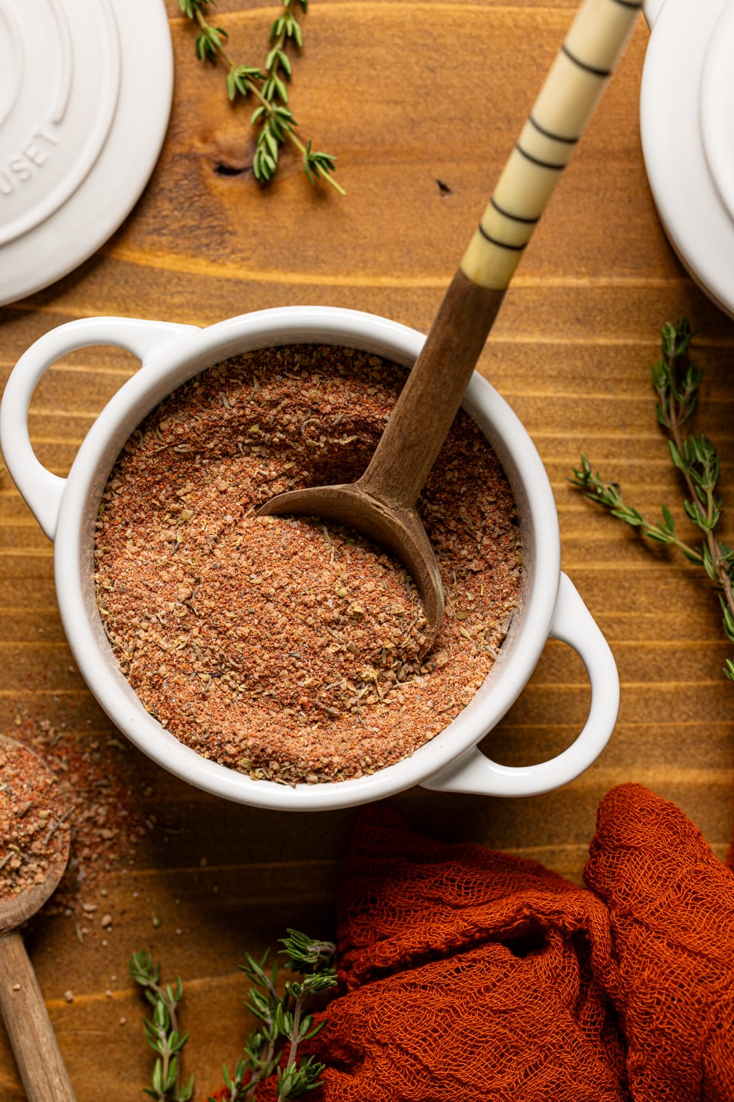 Seasoning in a mini white cocette with spoon.