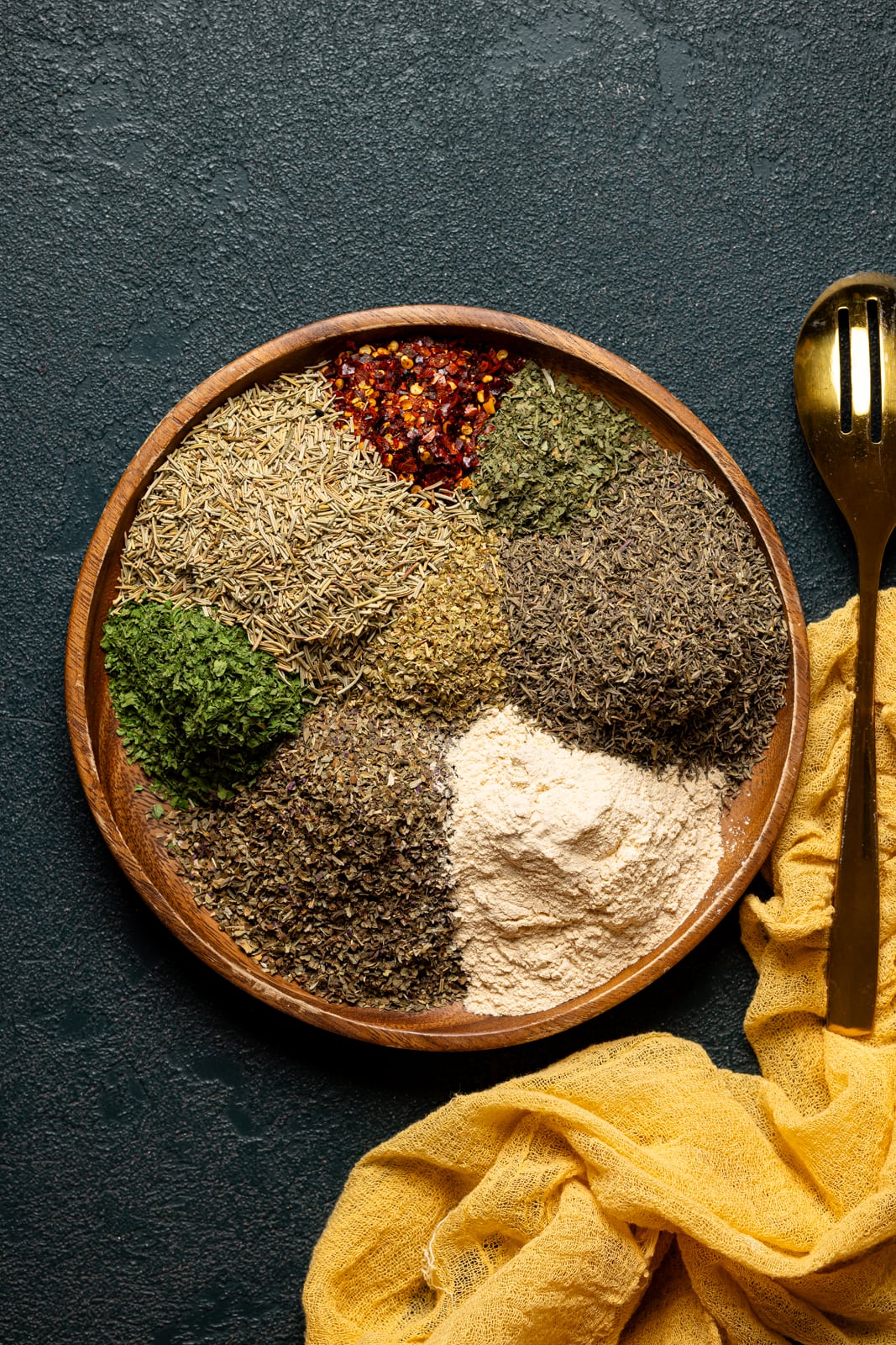 Seasonings on a brown wood plate.