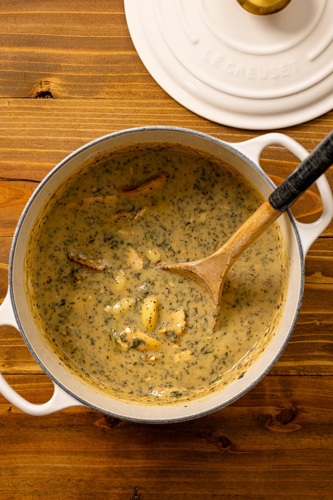 Dutch oven with soup and a spoon.