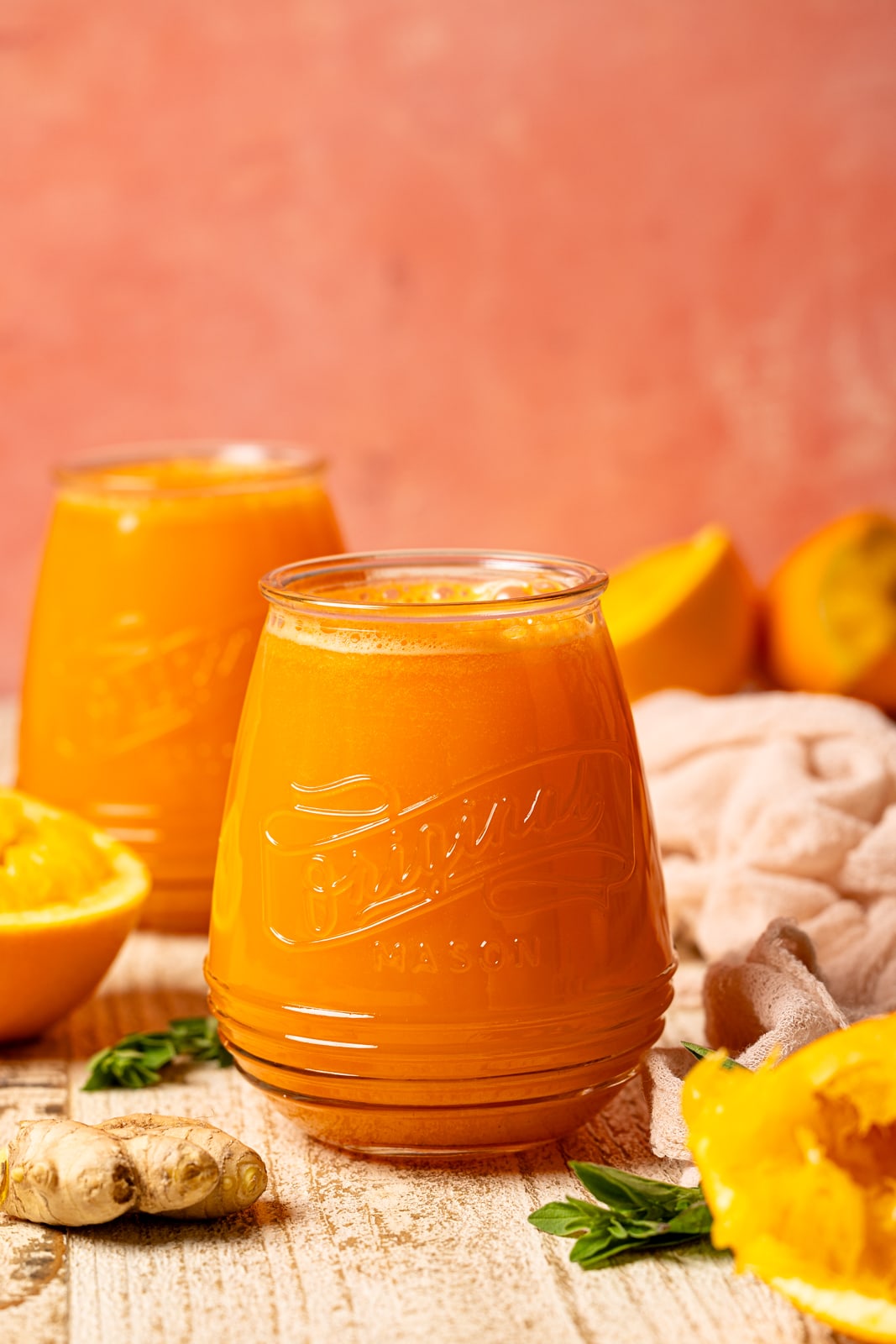 Juice in two mason jars with oranges and ginger.