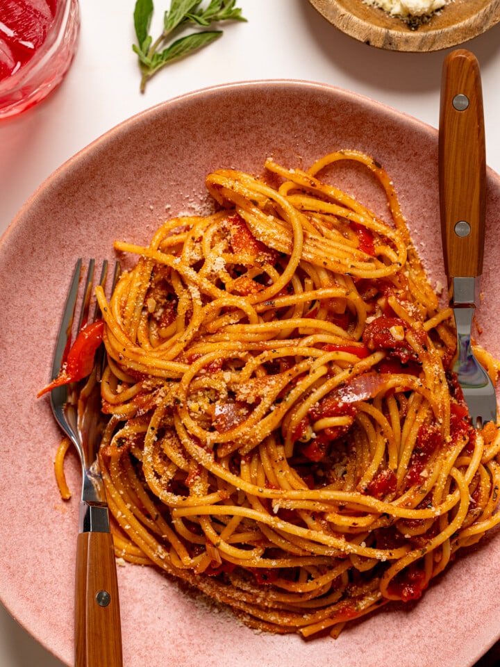 Up close shot of spaghetti in a pink plate.