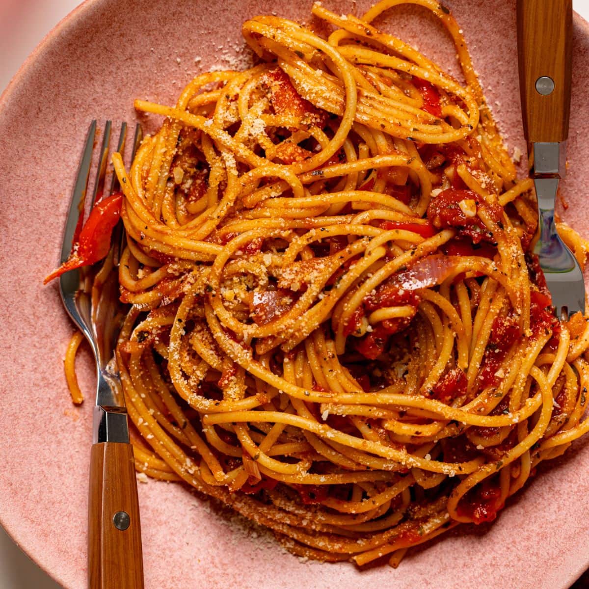 Up close shot of spaghetti in a pink plate.