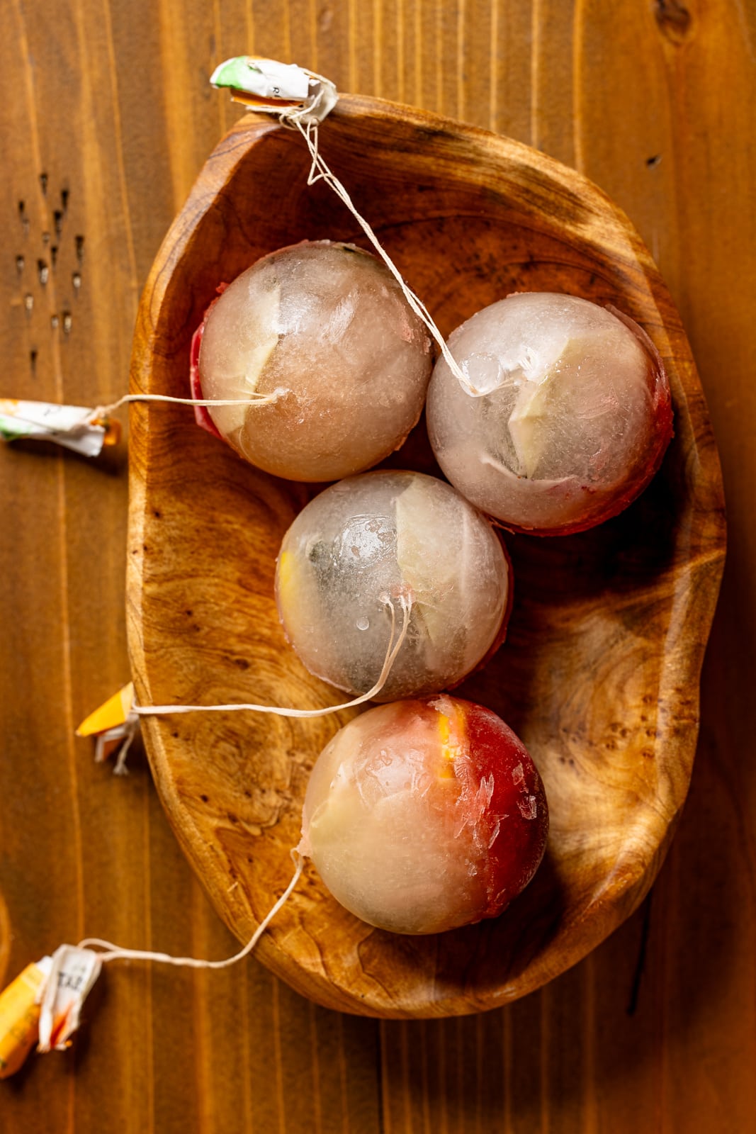 Jumbo ice cubes in a brown wood bowl.