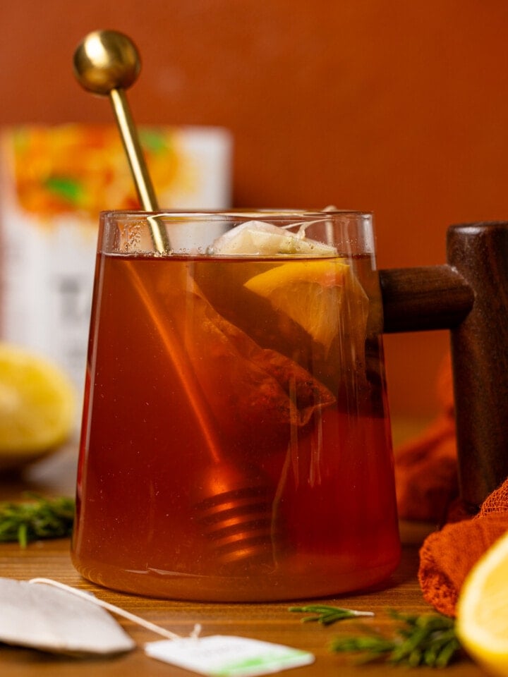 Up close shot of tea with honey stick.