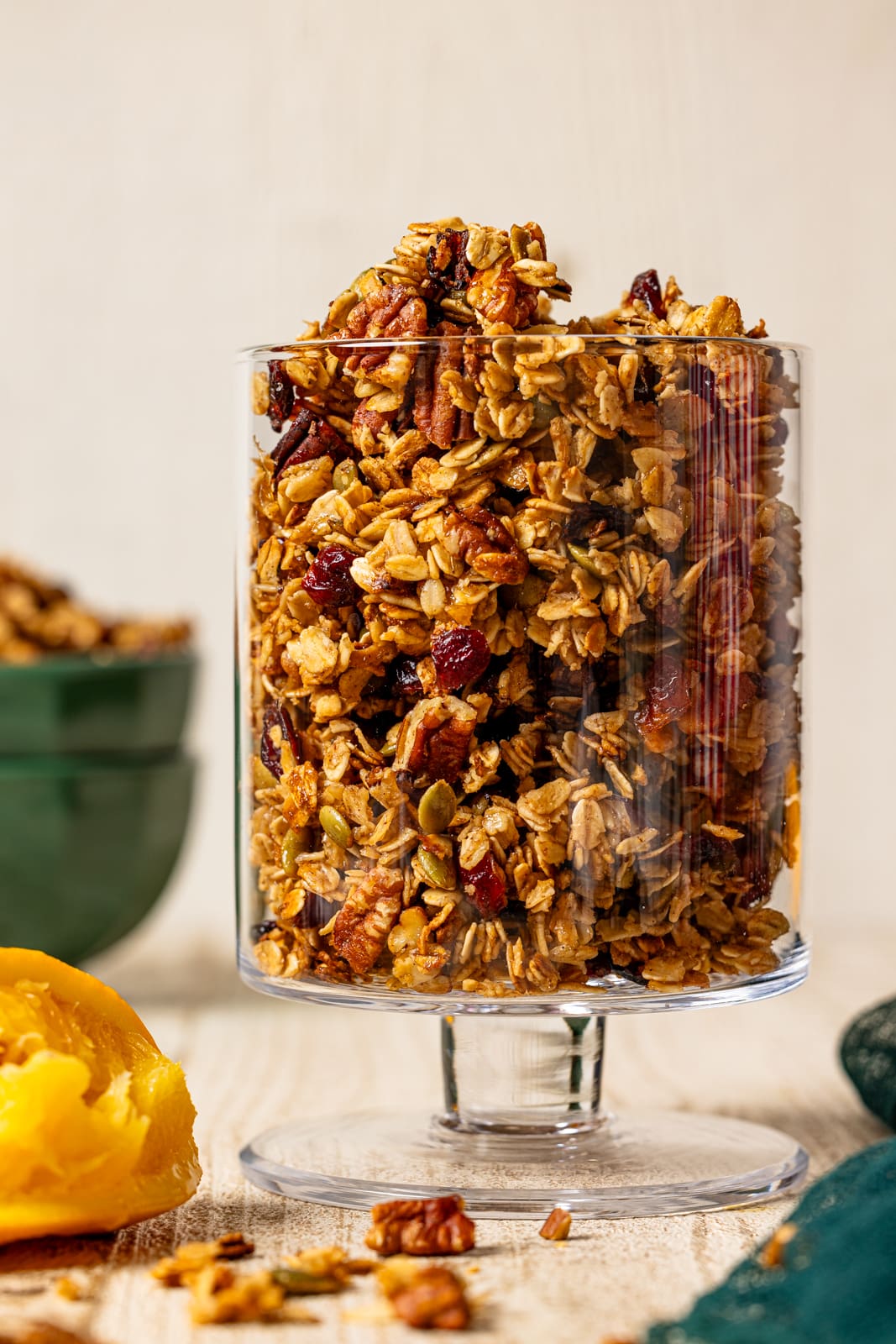 Up close shot of granola in a clear trifle bowl.