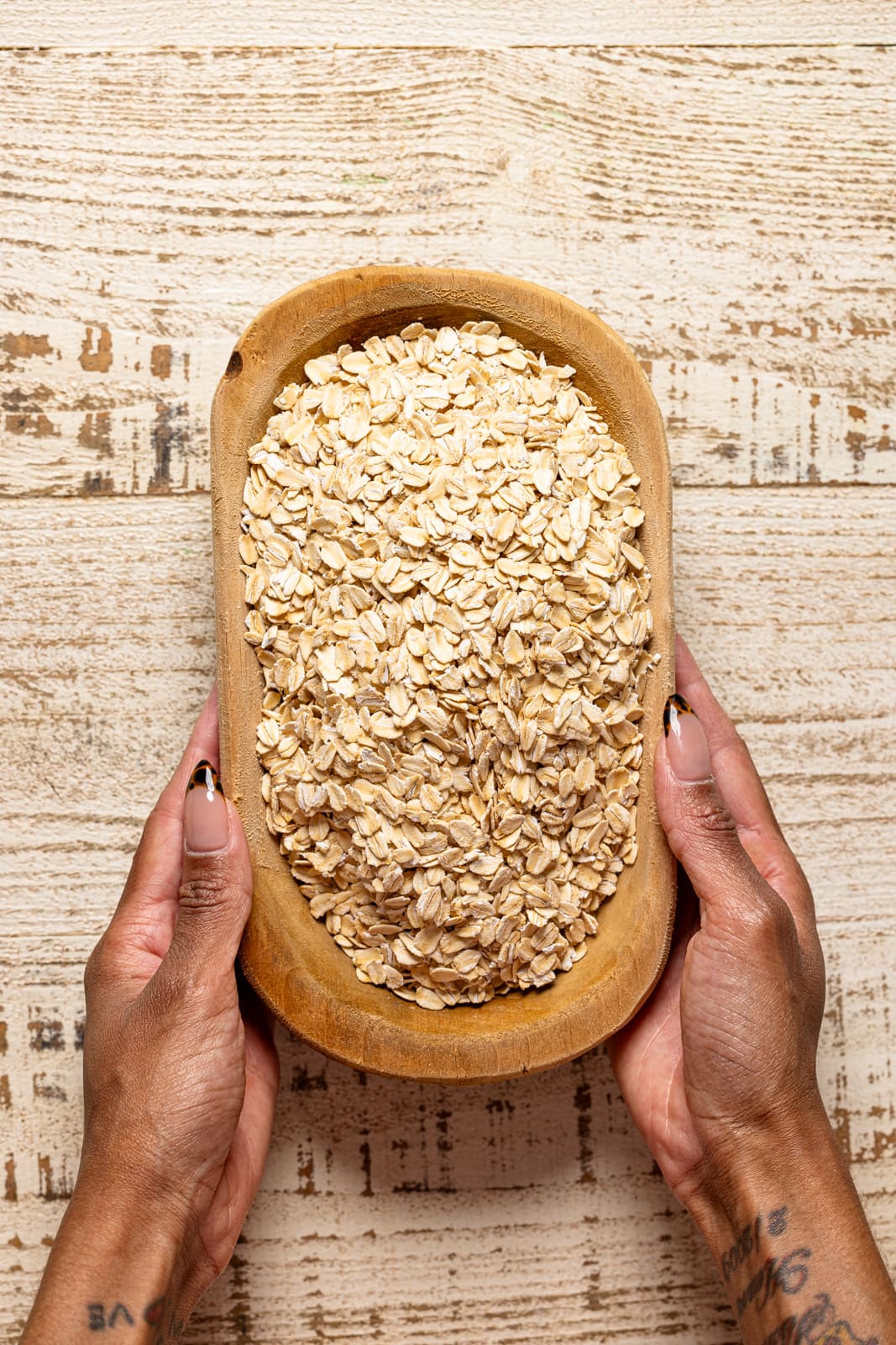 Oats in a bowl being held.