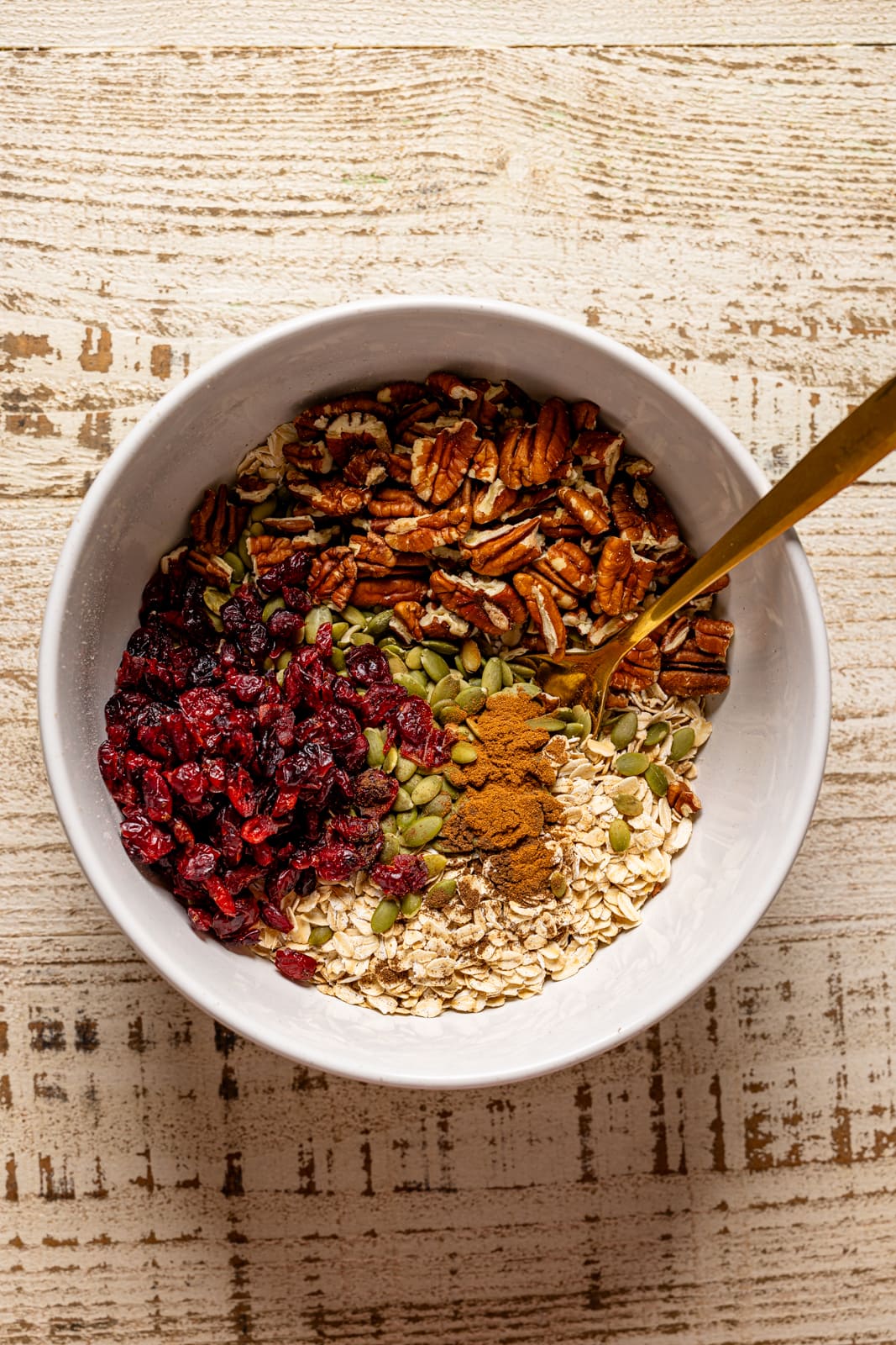 All ingredients together in a bowl with a spoon.