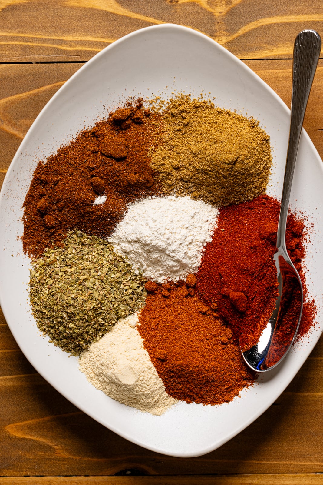 Seasoning on plate with a spoon.