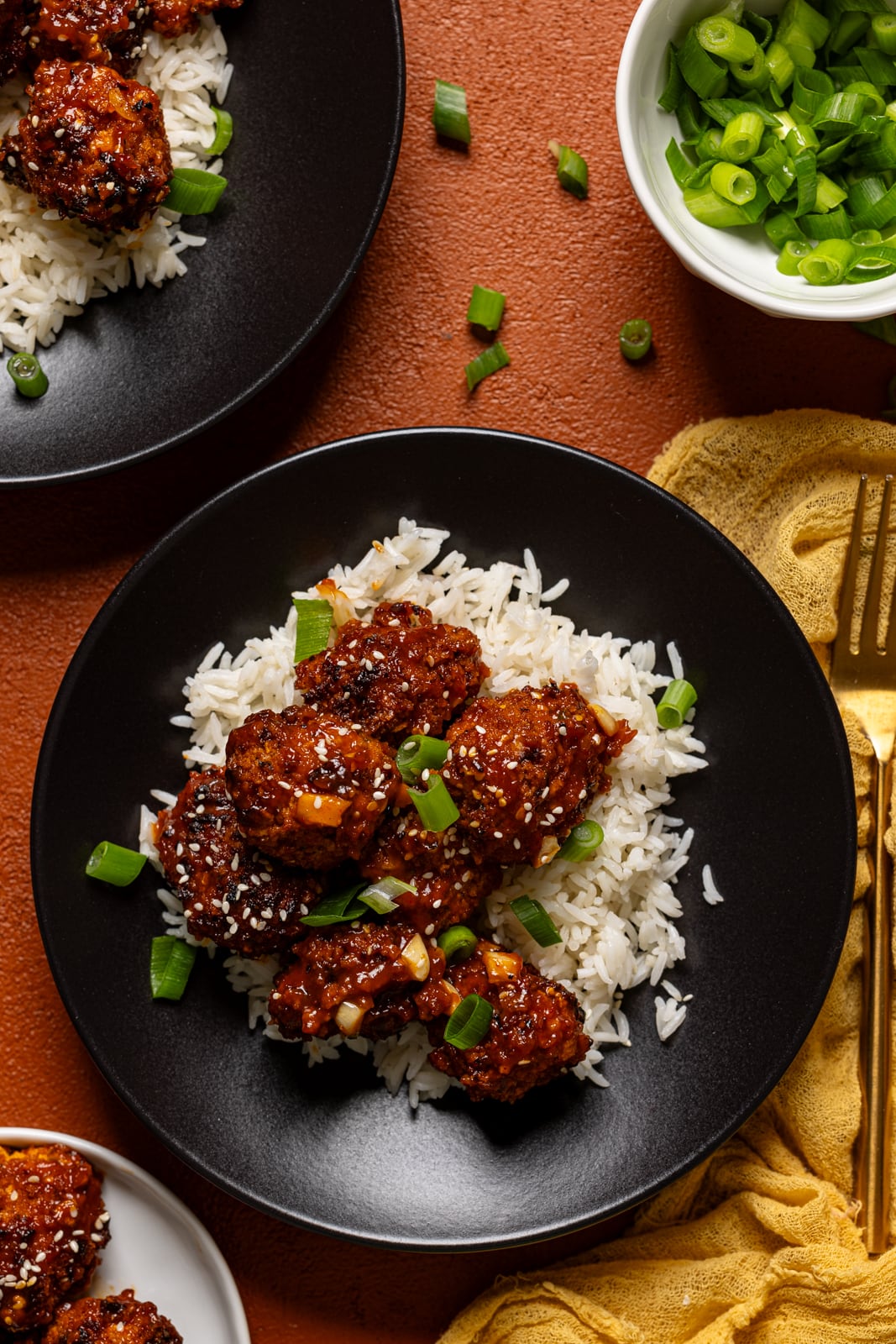 General Tso chicken in two plates with a fork.