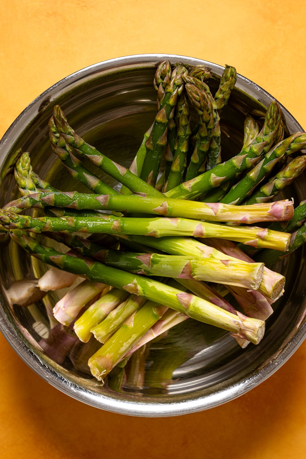 Asparagus in a silver bowl.