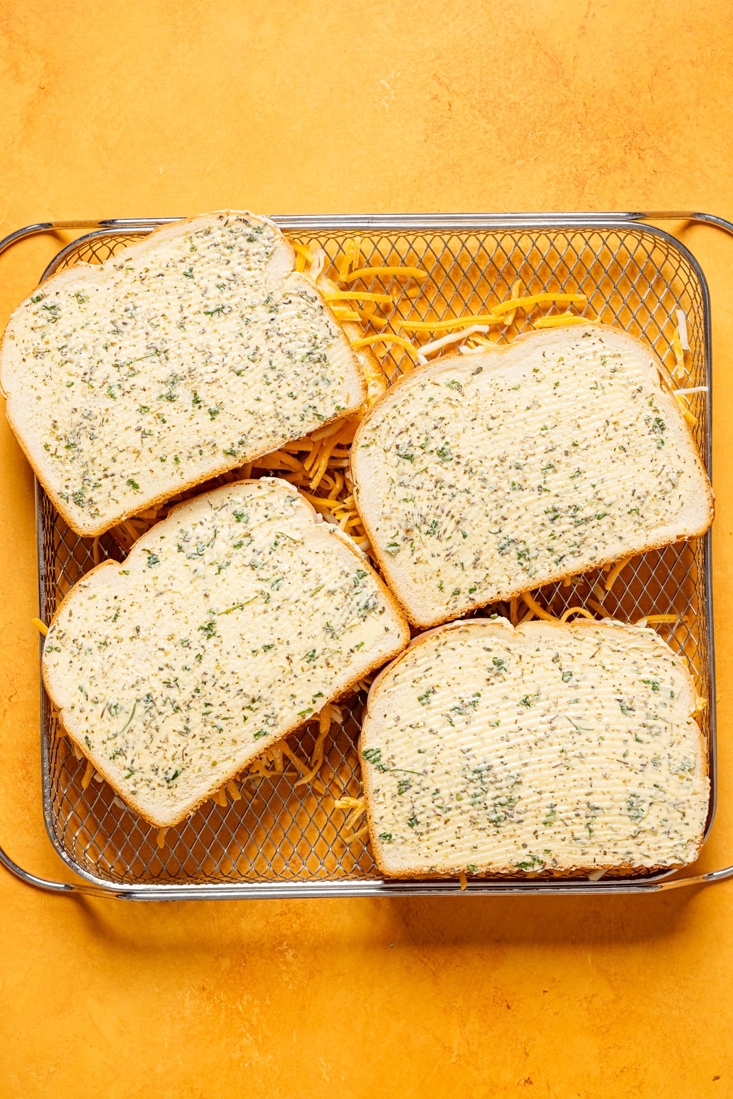 Assembled sandwiches in an Air Fryer basket.