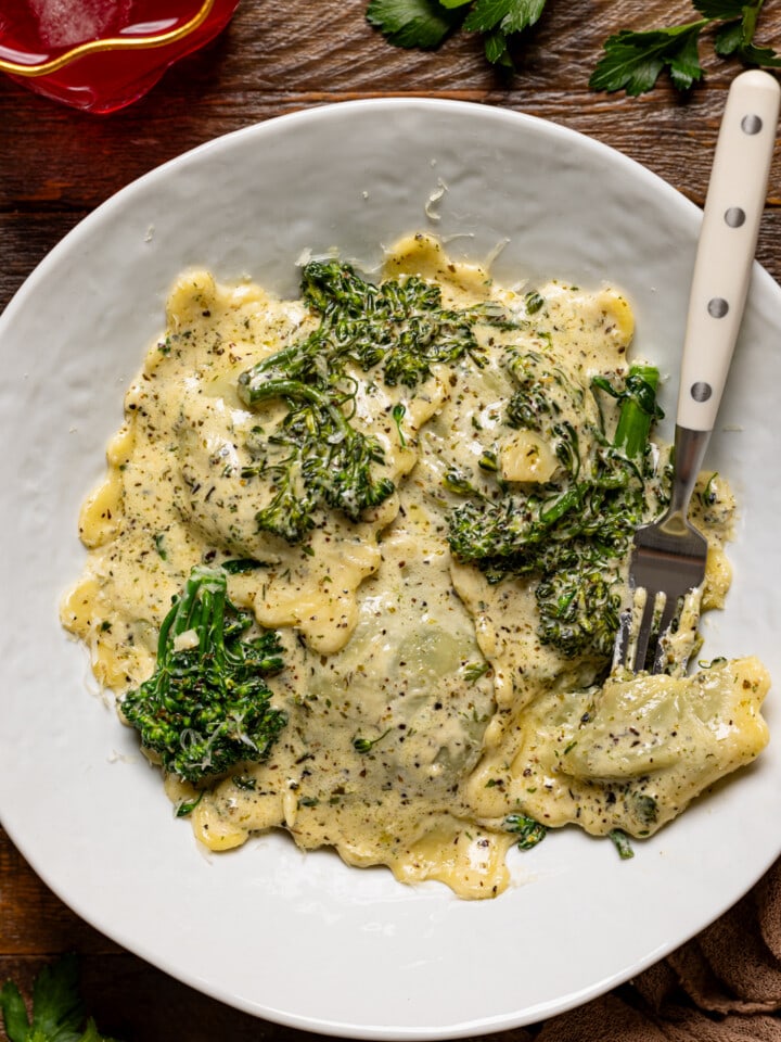 Up close shot of ravioli in a white plate.