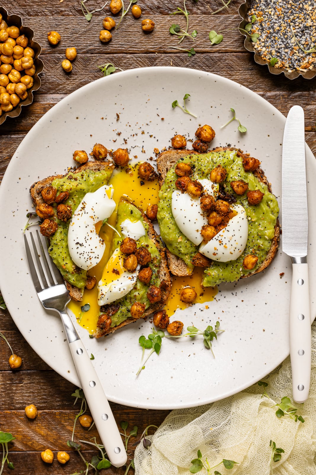 Toast on a white plate with knife and fork.