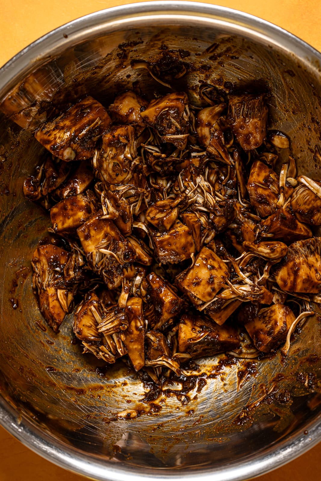 Marinated jackfruit in a silver bowl.