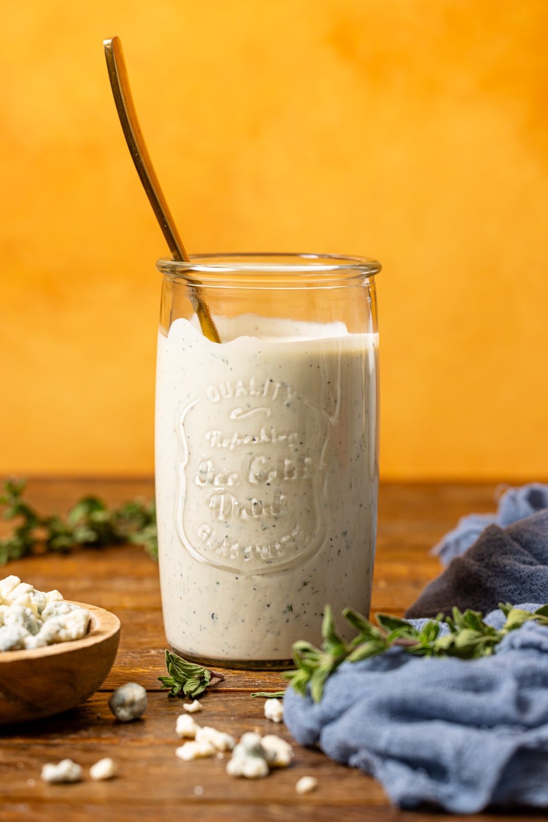 Blue cheese dressing in a mason jar with a spoon.