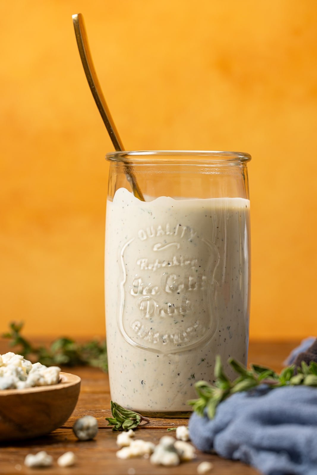 Up close shot of Dressing in a mason jar with a spoon.