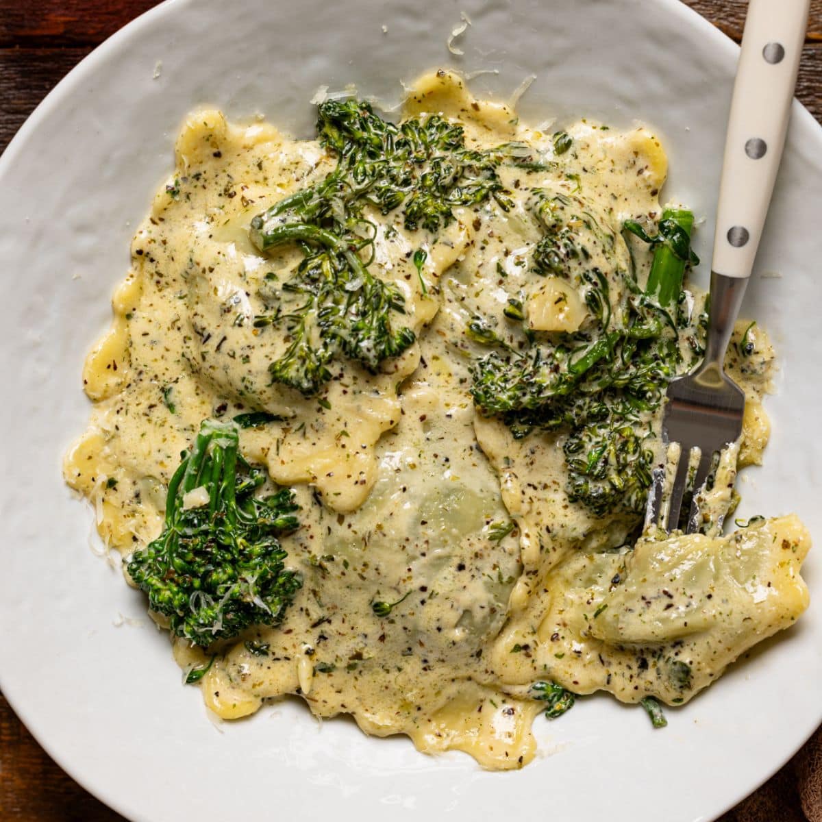 Up close shot of ravioli in a white plate.