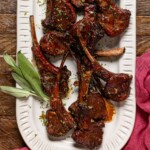 Lamb chops on a platter with sage.