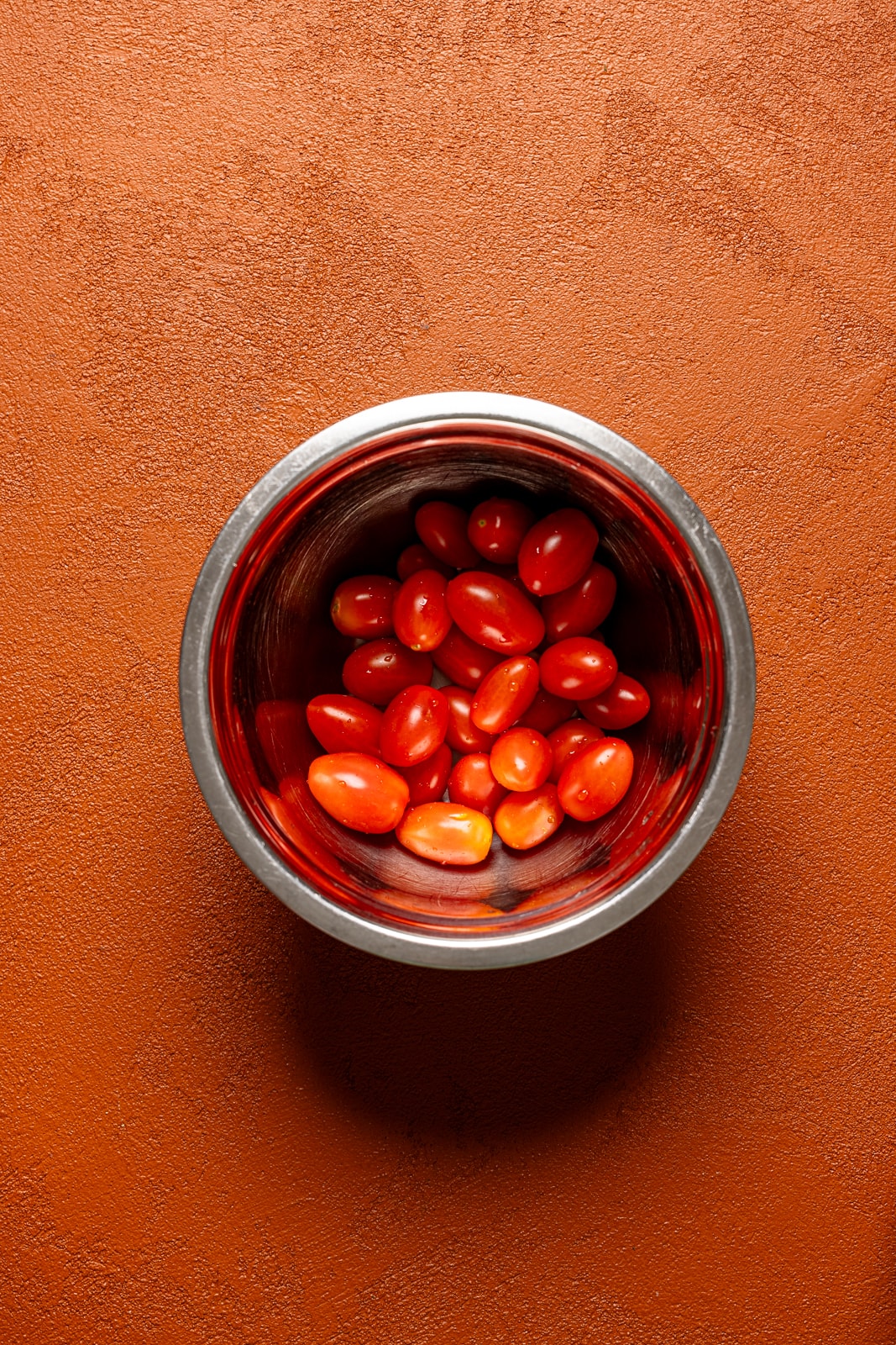 Tomatoes in a silver bowl.