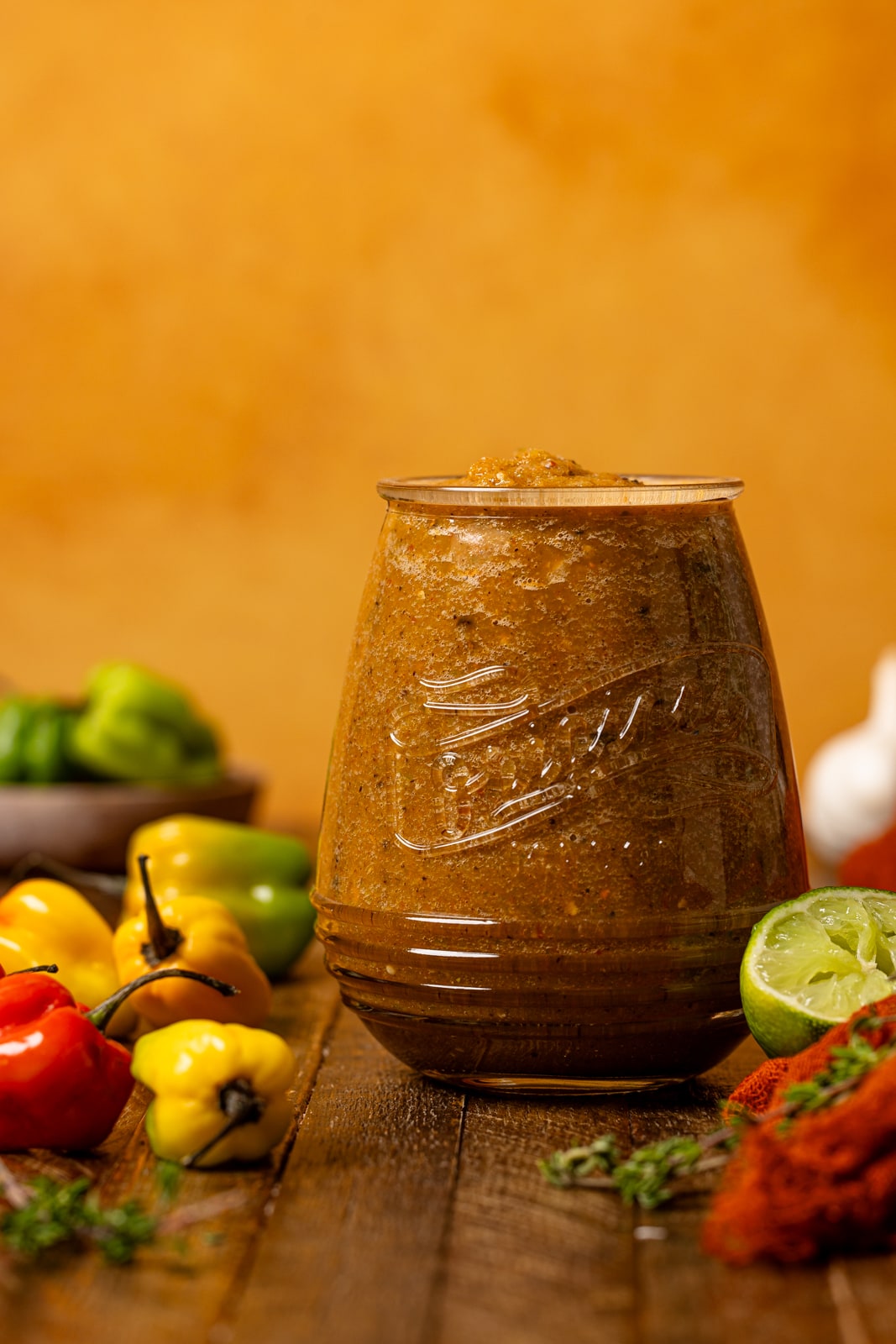 Pepper sauce in a mason jar with scotch bonnet peppers.