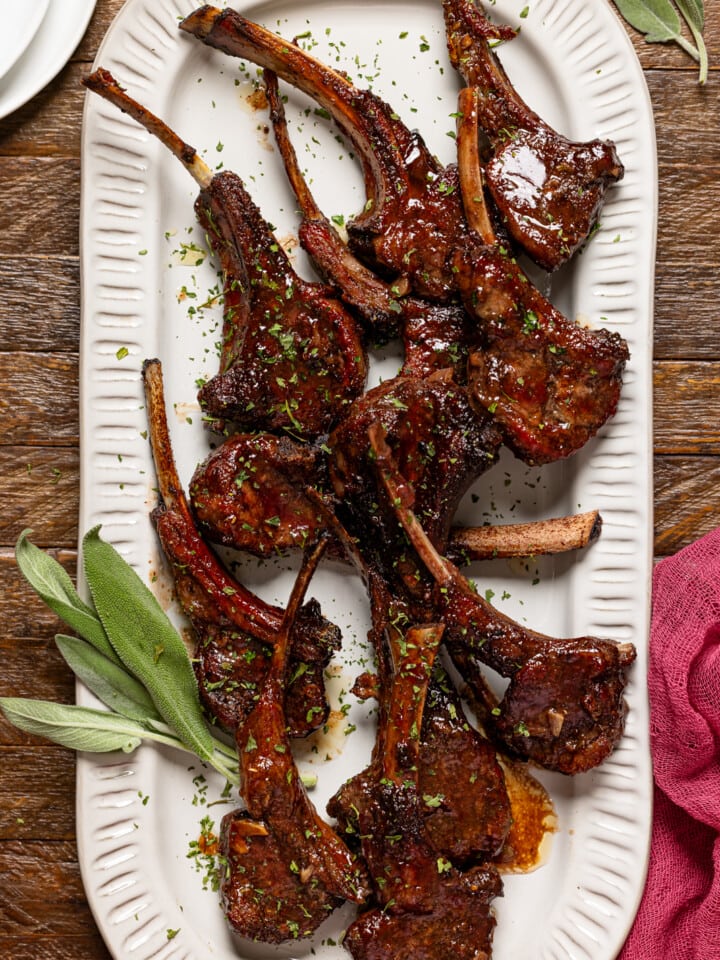 Lamb chops on a platter with sage.