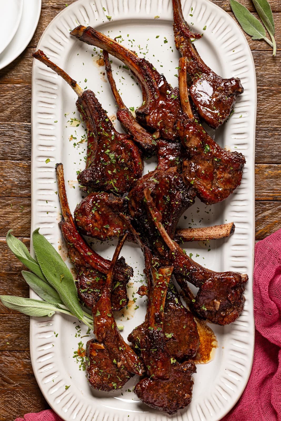 Lamb chops on a platter with sage.