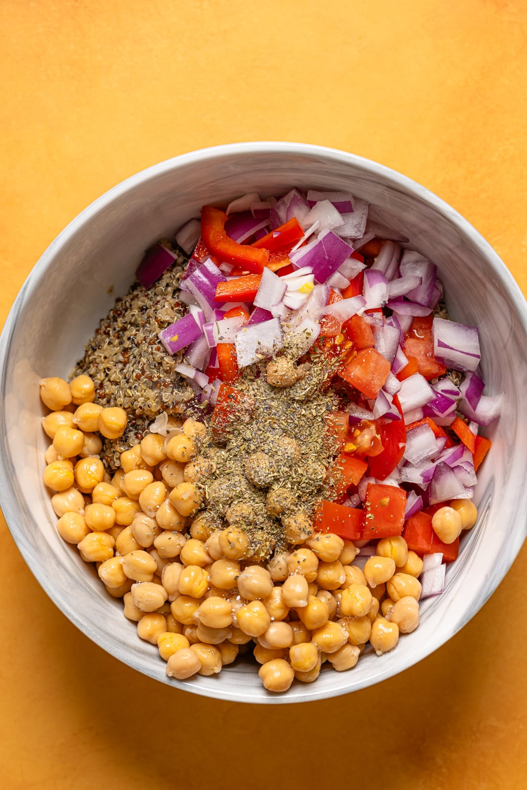 Ingredients in a bowl on an orange table.